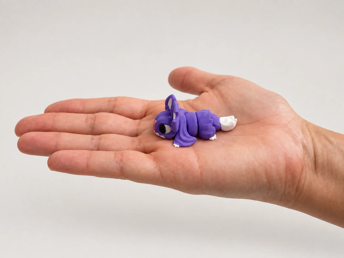 Bat CHONK articulated fidget resting in an open hand.