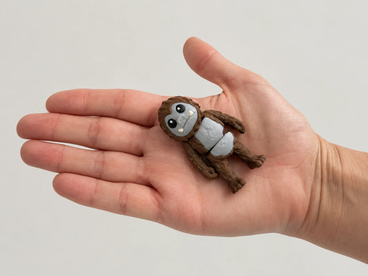 Bigfoot Fidget articulated fidget resting in an open hand.