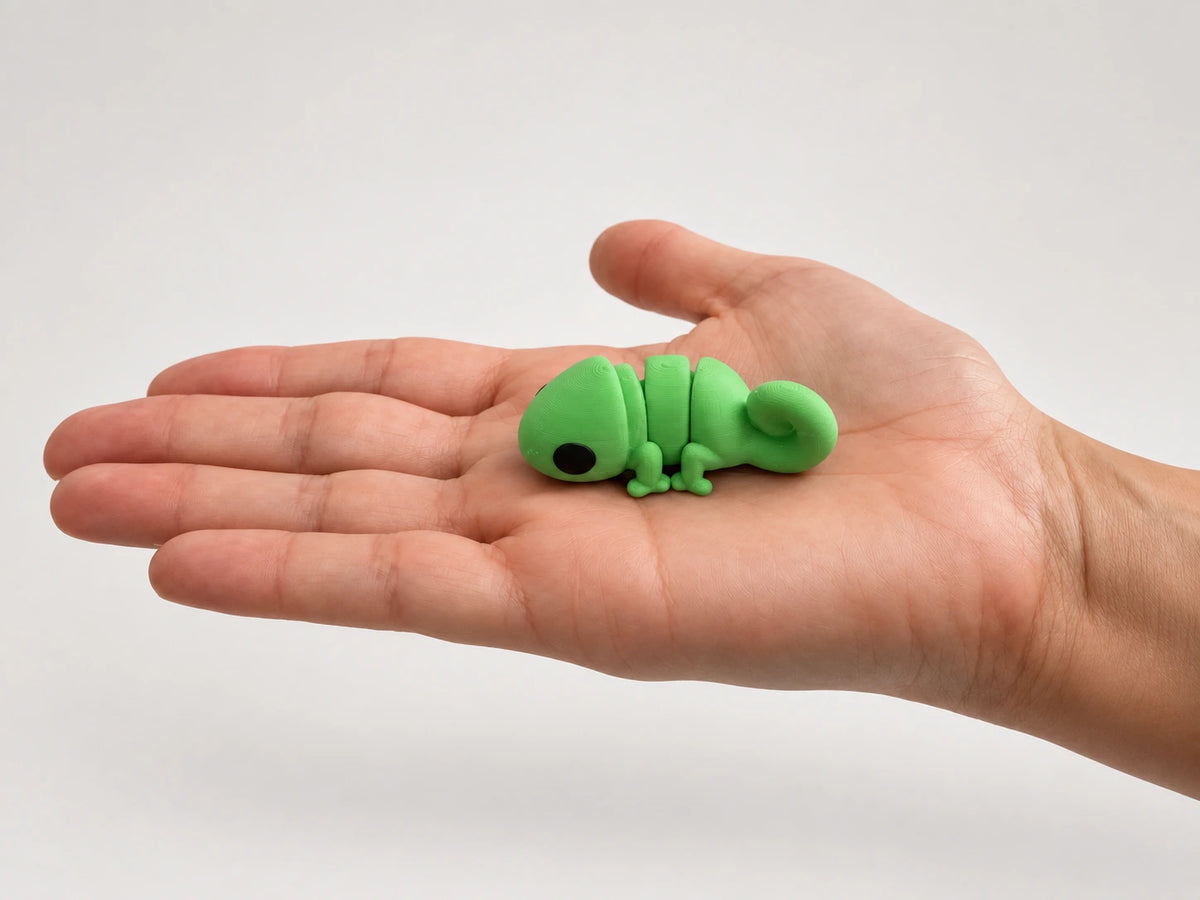 Cassie (Chameleon) articulated fidget resting in an open hand.