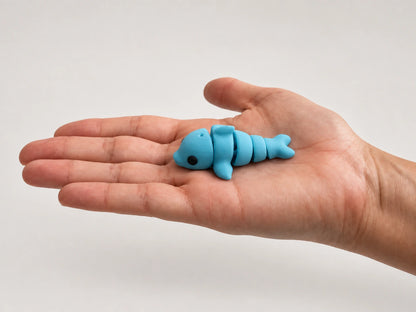 Dennis (Dolphin) articulated fidget resting in an open hand.