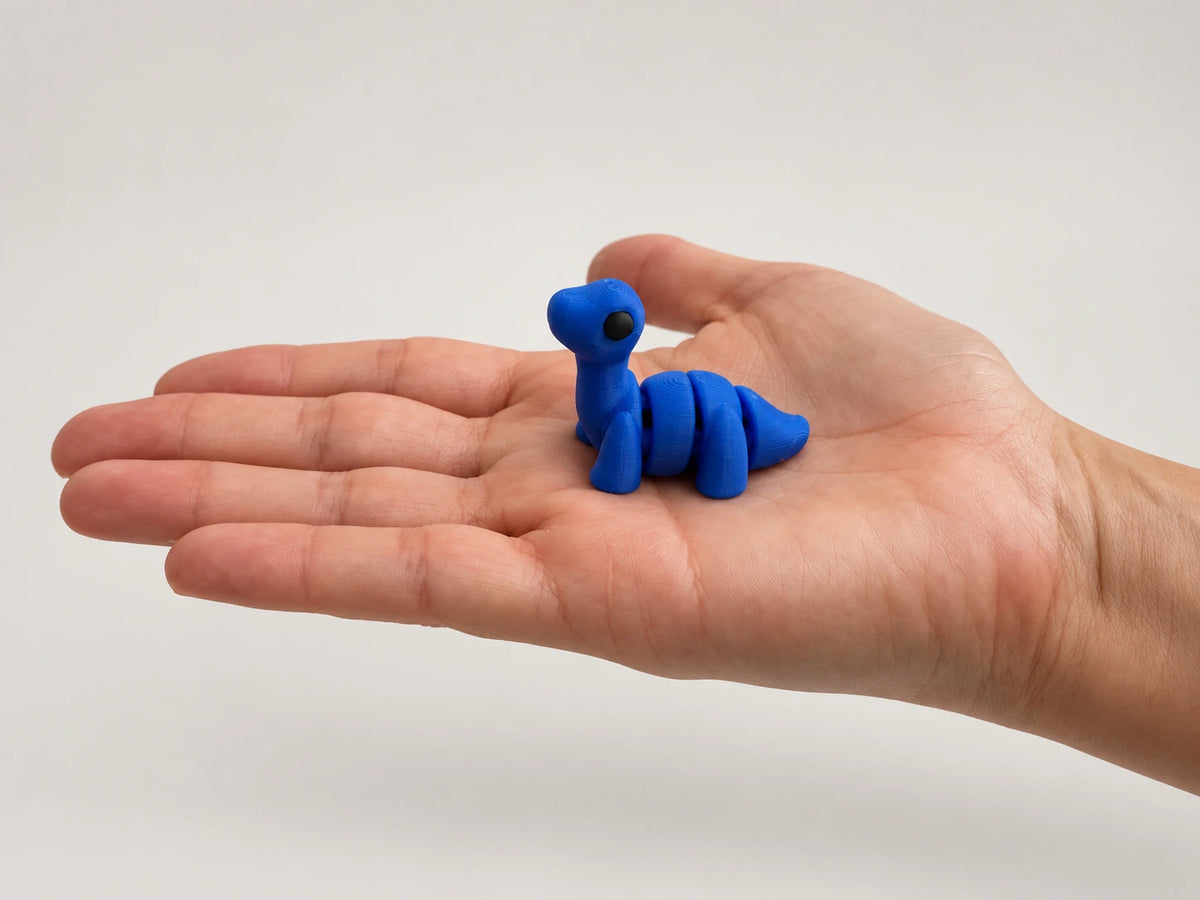 Dip (Diplodocus) articulated fidget resting in an open hand.