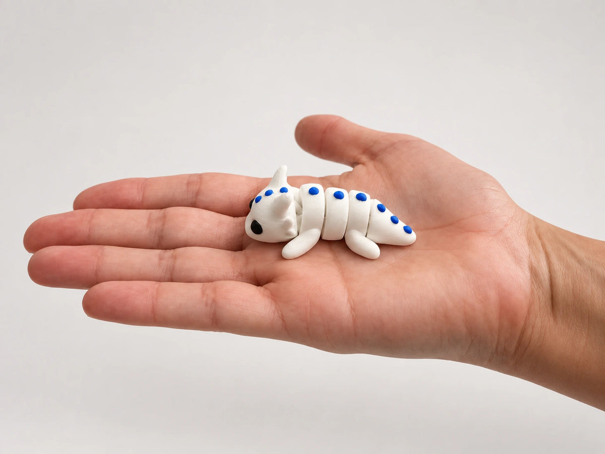 Dragon Fidget articulated fidget resting in an open hand.
