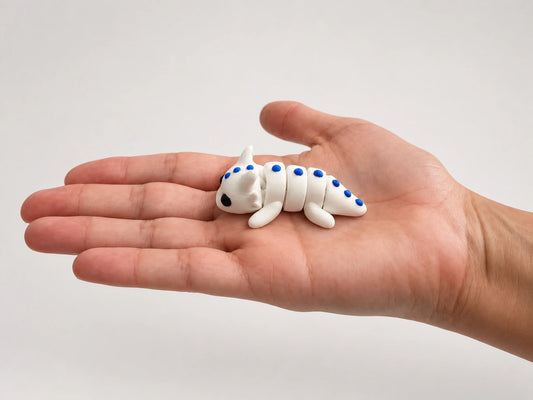 Dragon Fidget articulated fidget resting in an open hand.