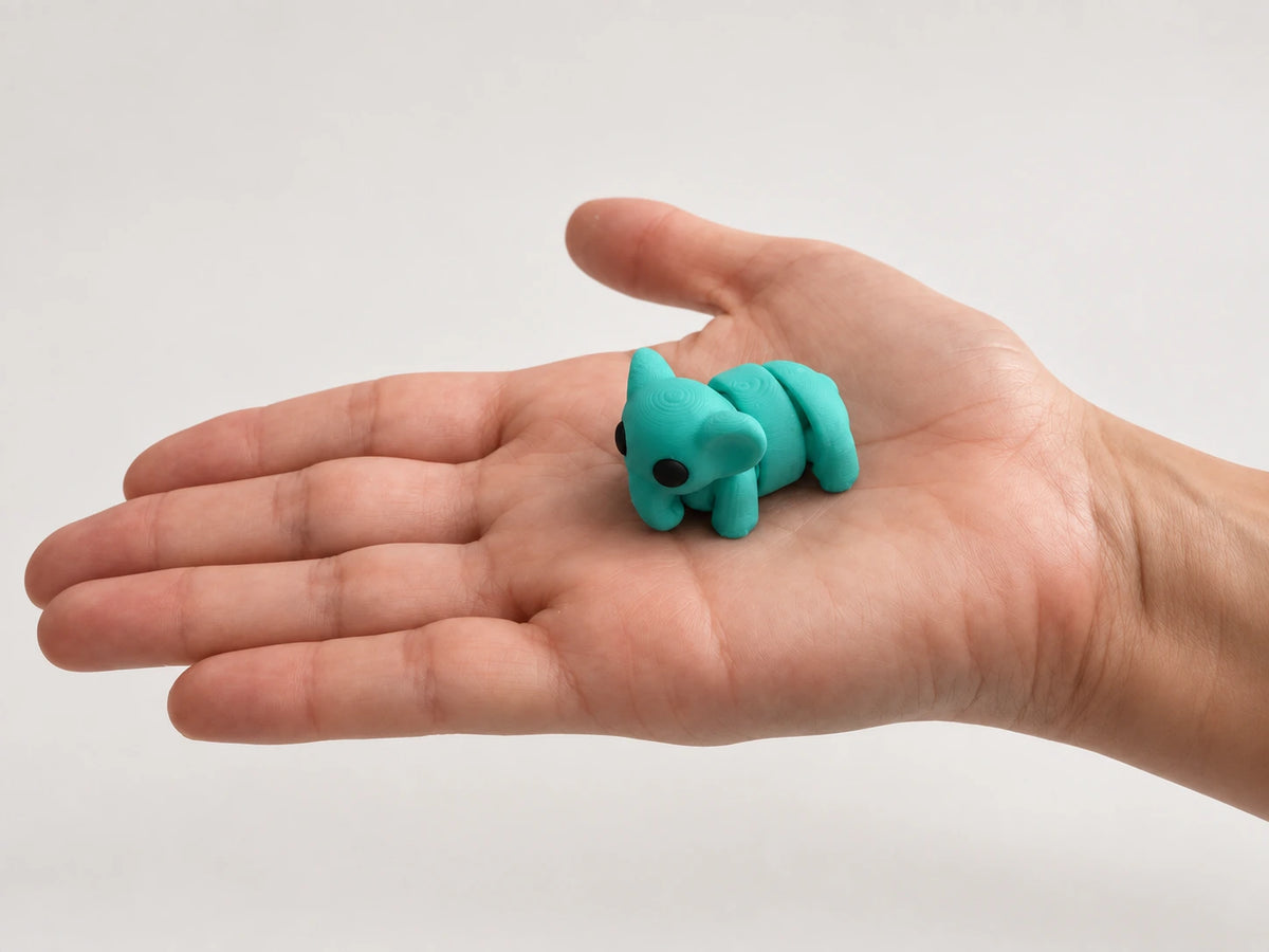 Elsie (Elephant) articulated fidget resting in an open hand.