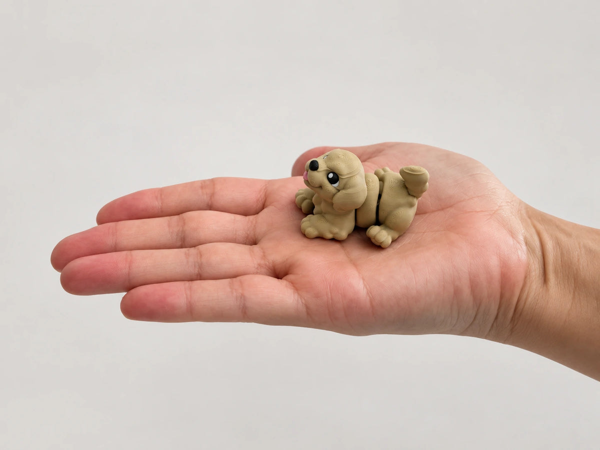 Floppy-Ear Dog Fidget articulated fidget resting in an open hand.