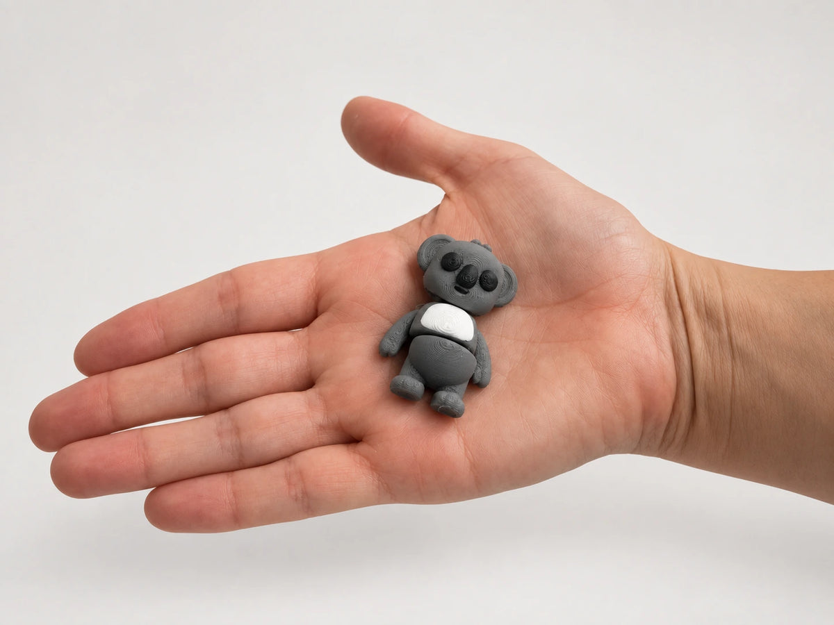 Kirk (Koala) articulated fidget resting in an open hand.