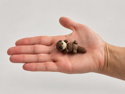 Otter Fidget articulated fidget resting in an open hand.