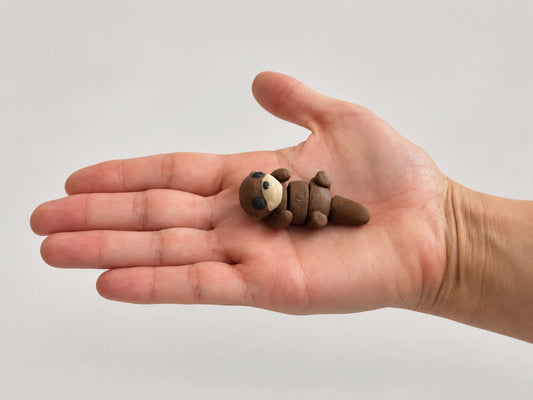 Otter Fidget articulated fidget resting in an open hand.