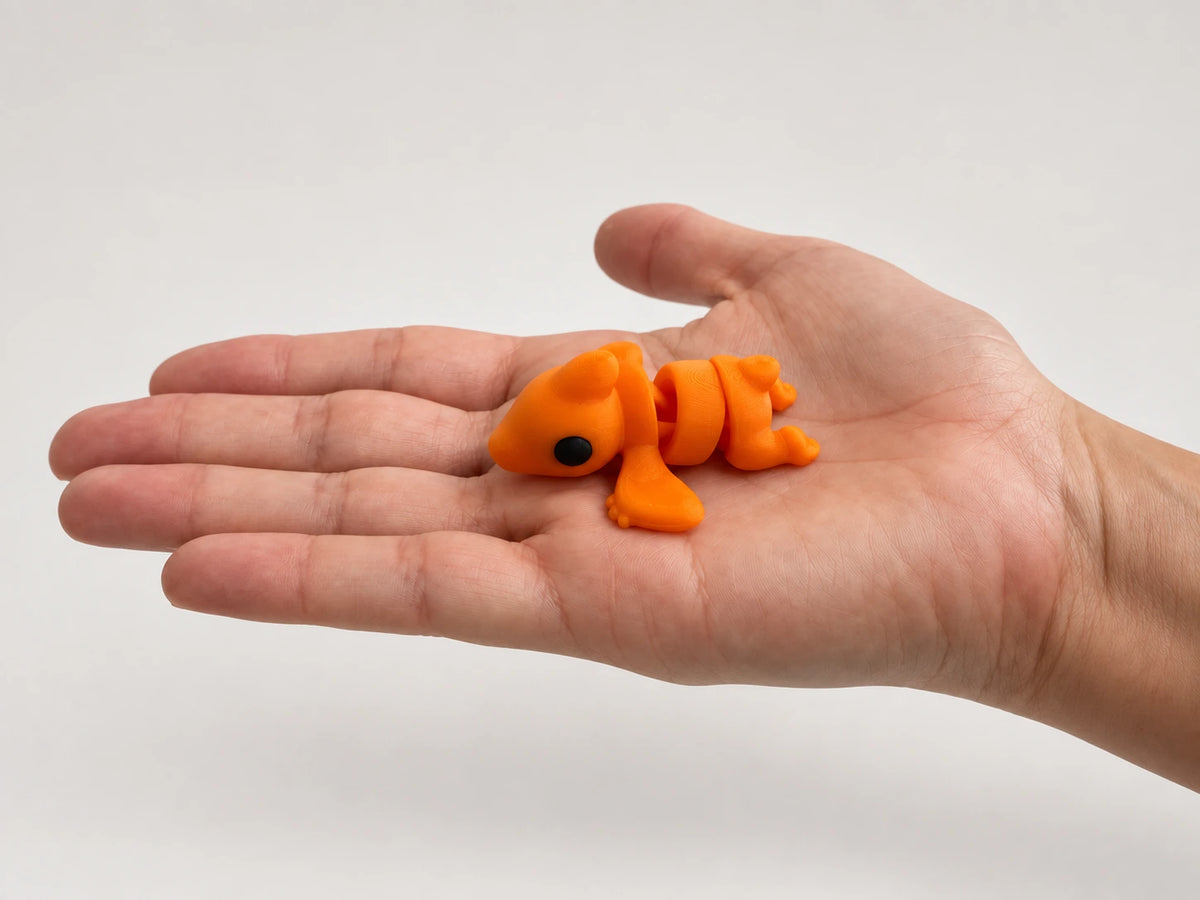 Percy Pterodactyl articulated fidget resting in an open hand.