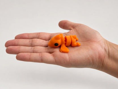 Percy Pterodactyl articulated fidget resting in an open hand.
