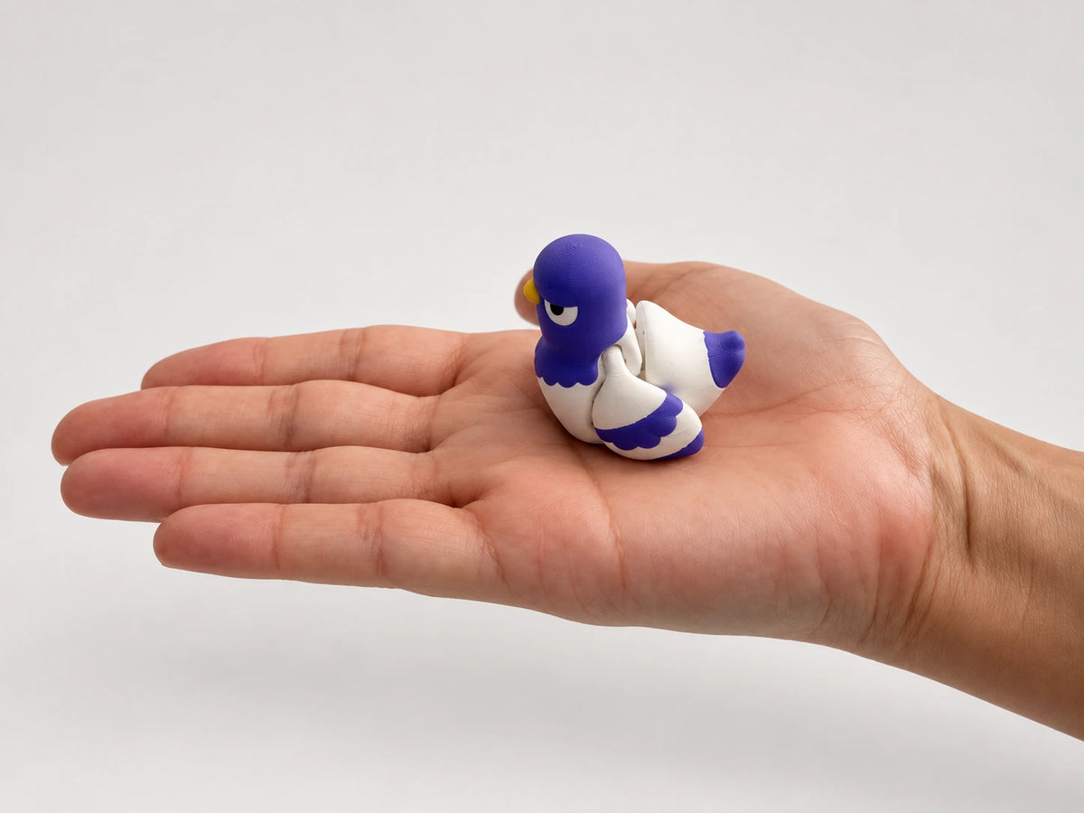 Peter Pigeon articulated fidget resting in an open hand.