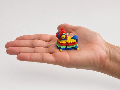 Pinata Chonk articulated fidget resting in an open hand.