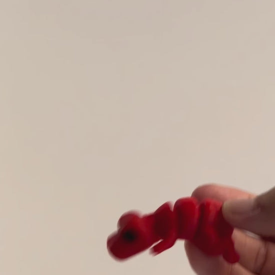 Timmy (T-Rex) shown moving in a hand.