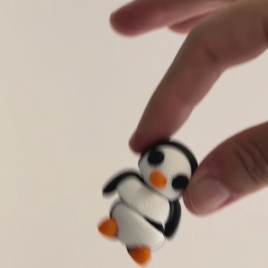 Parker (Penguin) shown moving in a hand.