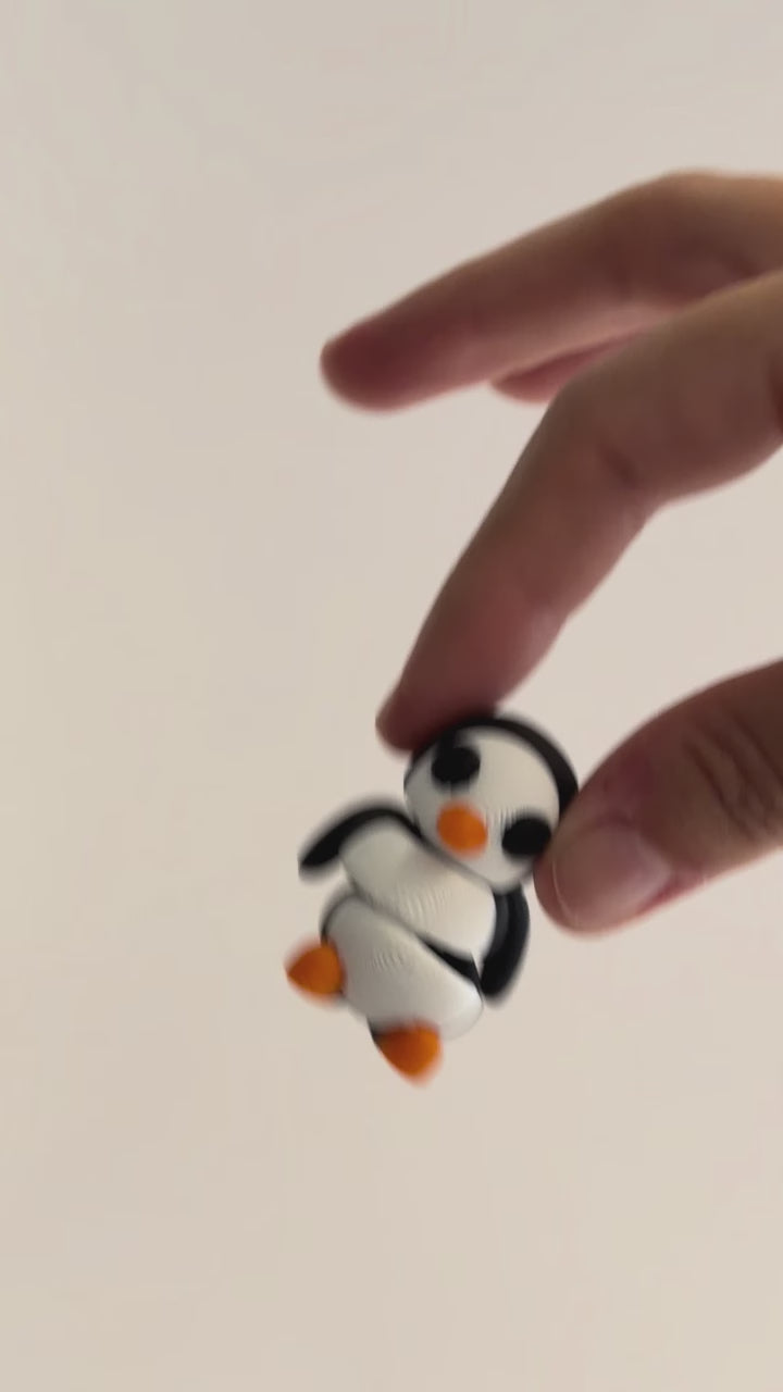 Parker (Penguin) shown moving in a hand.