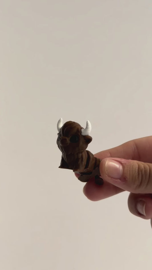 Brown bull articulated fidget shown moving in a hand.
