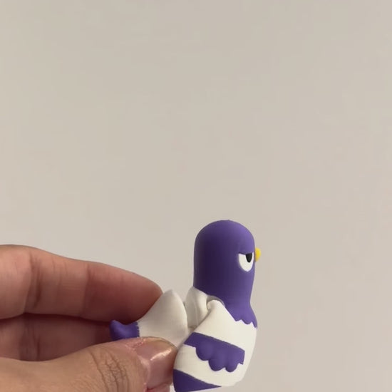 Peter Pigeon shown moving in a hand.