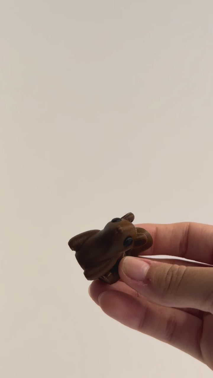 Squirrel Fidget shown moving in a hand.