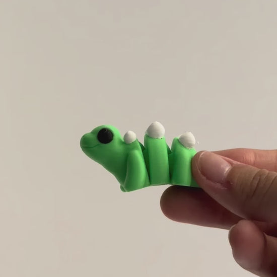 Sara (Stegosaurus) shown moving in a hand.
