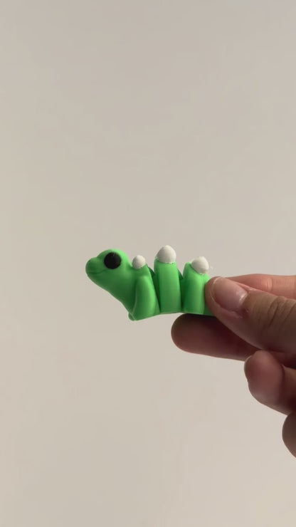 Sara (Stegosaurus) shown moving in a hand.