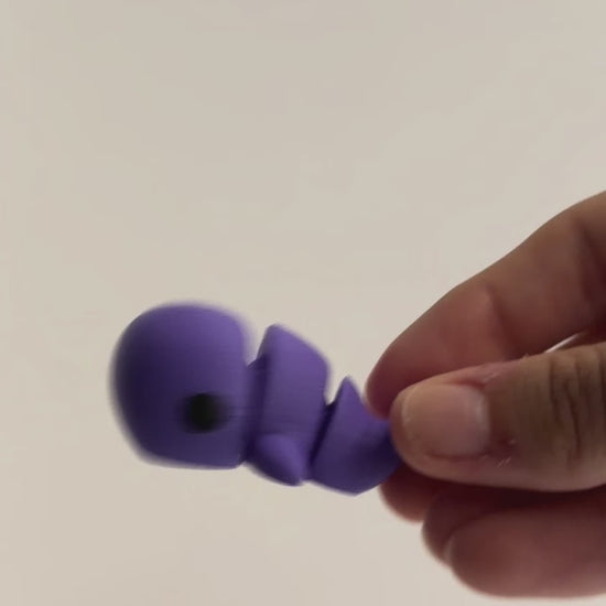 Whale Fidget shown moving in a hand.
