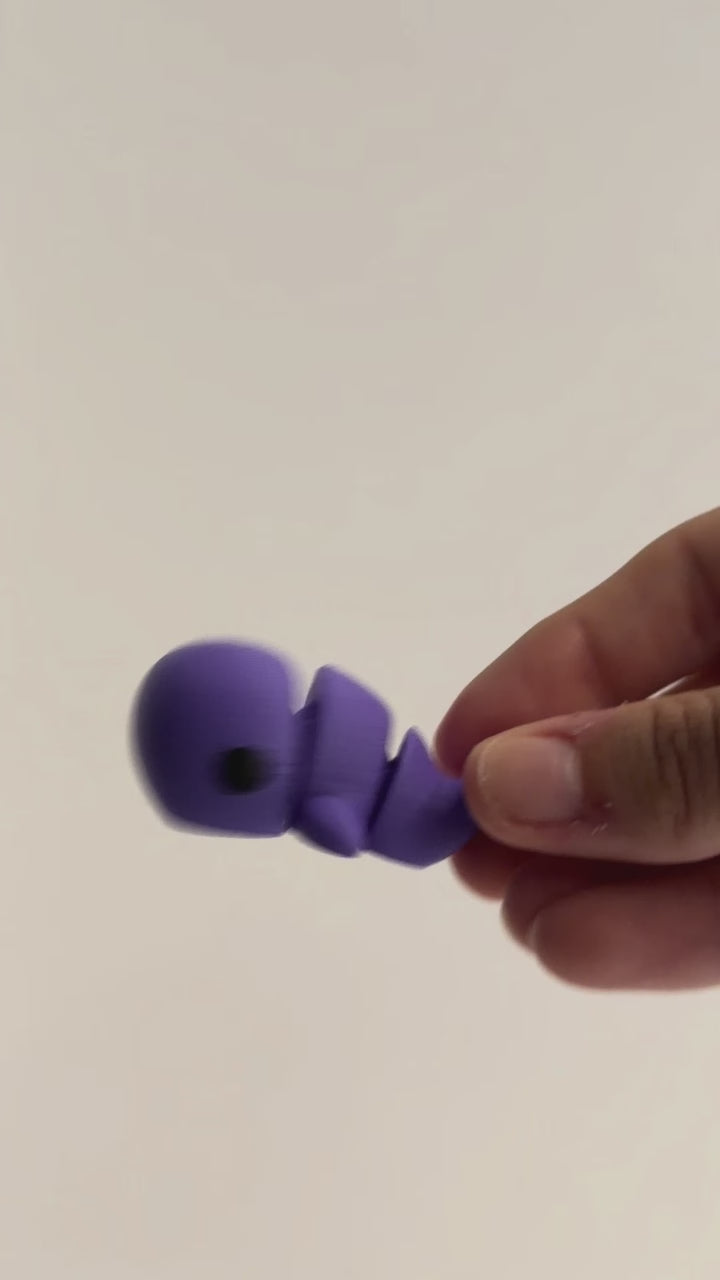 Whale Fidget shown moving in a hand.