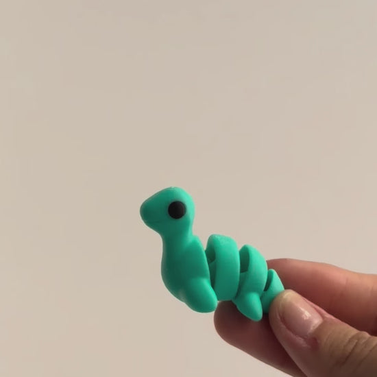 Nessie (Loch Ness Monster) shown moving in a hand.
