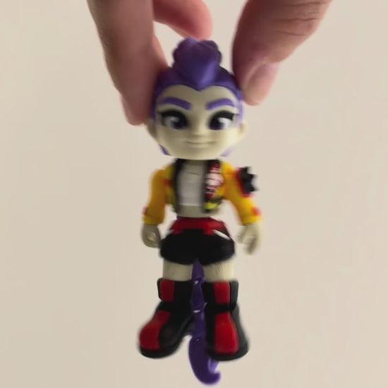 Rumi – K-pop Demon Hunters Figure shown moving in a hand.