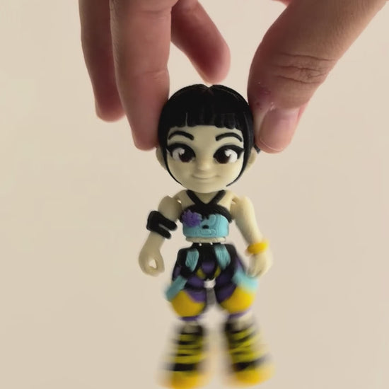 Zoey – K-pop Demon Hunters Figure shown moving in a hand.