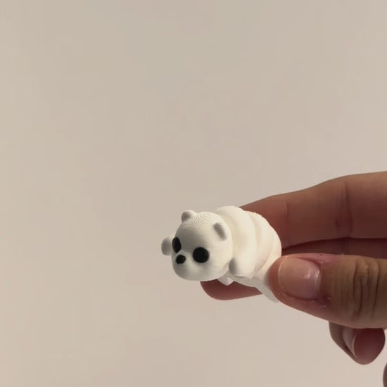 Paisley (Polar Bear) shown moving in a hand.