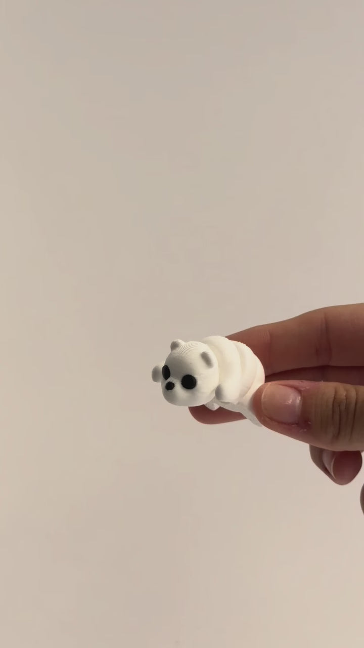 Paisley (Polar Bear) shown moving in a hand.