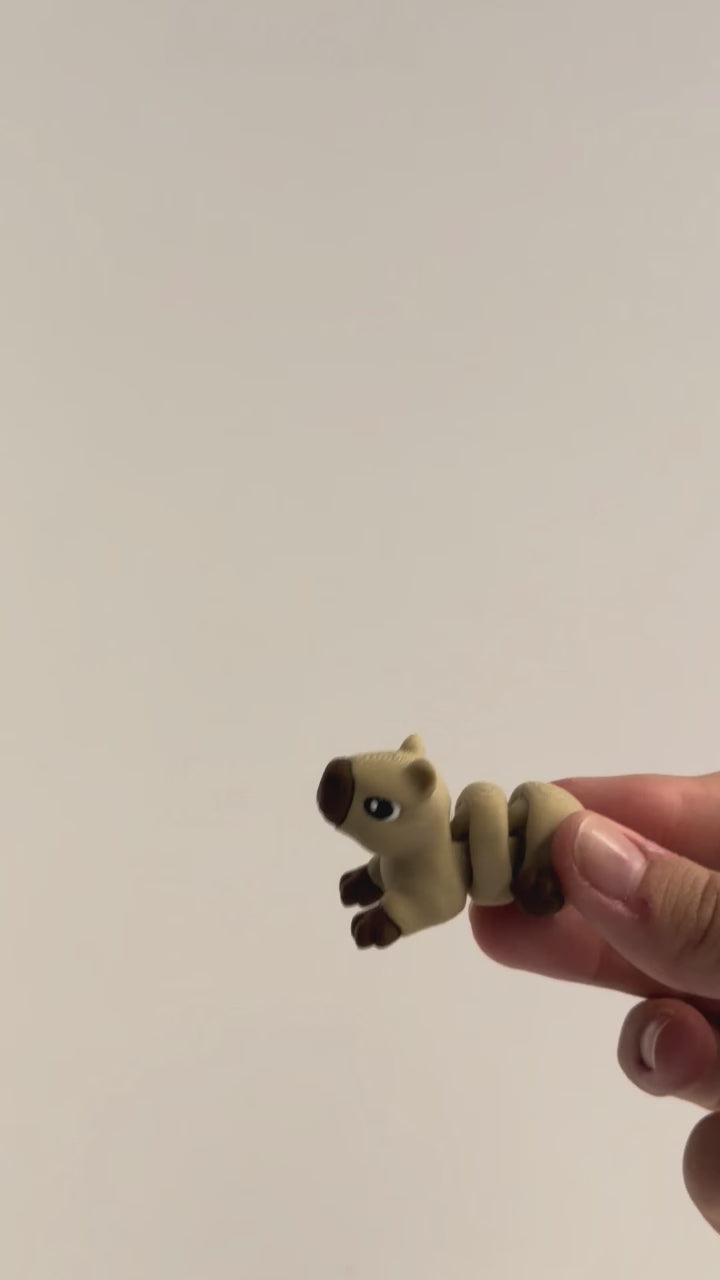 Capybara articulated fidget shown moving in a hand.