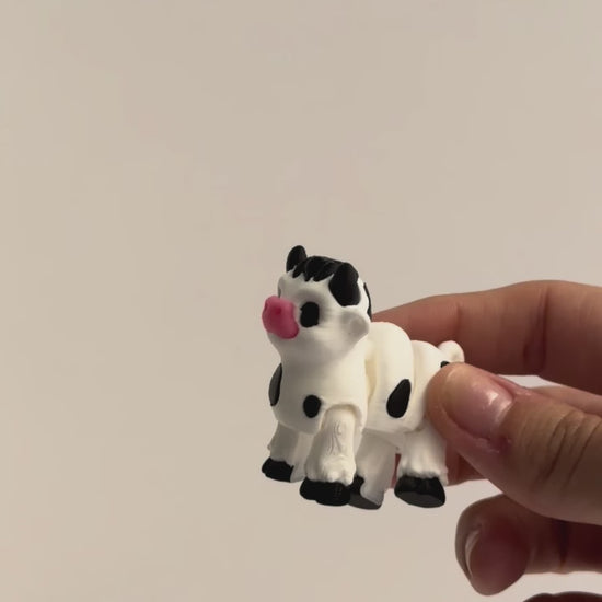 Cow Fidget shown moving in a hand.