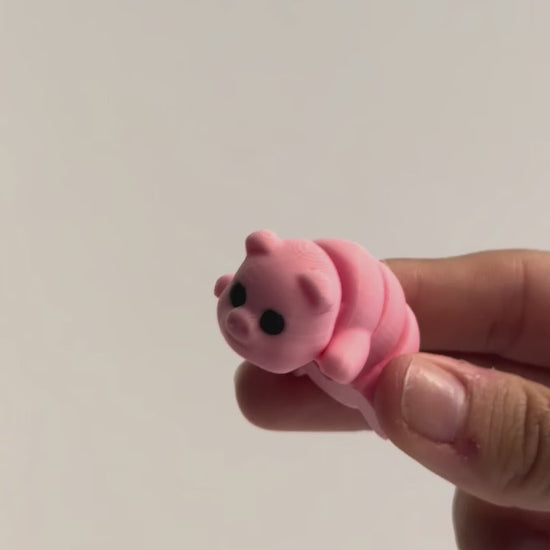 Penelope (Pig) shown moving in a hand.