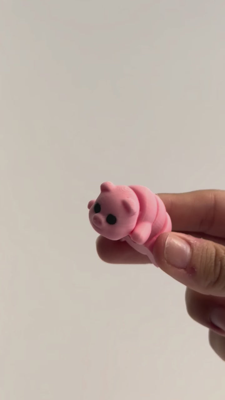 Penelope (Pig) shown moving in a hand.
