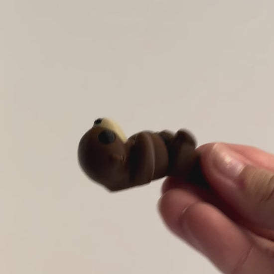 Otter Fidget shown moving in a hand.