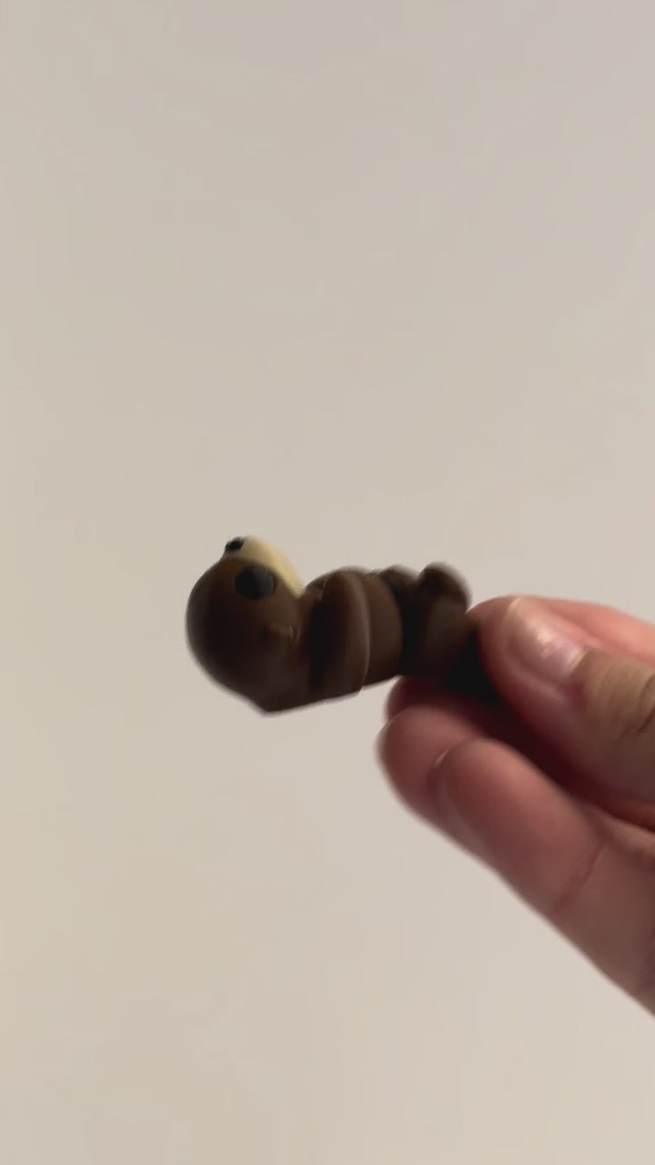 Otter Fidget shown moving in a hand.