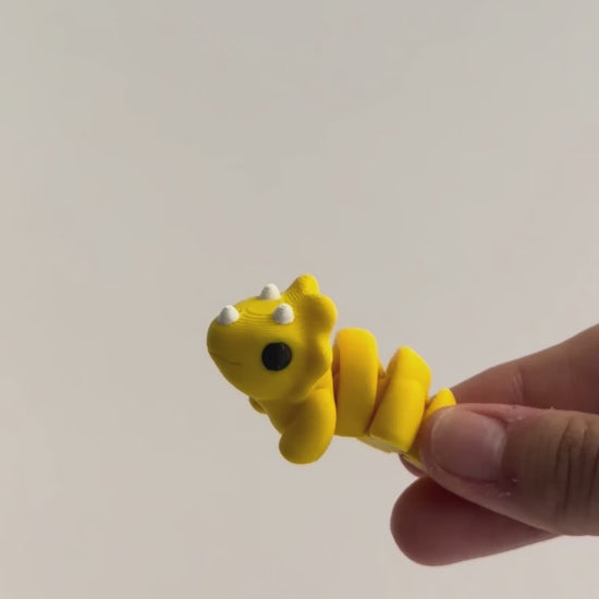 Tilly (Triceratops) shown moving in a hand.