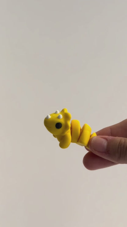 Tilly (Triceratops) shown moving in a hand.