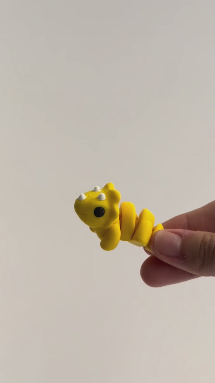 Tilly (Triceratops) shown moving in a hand.