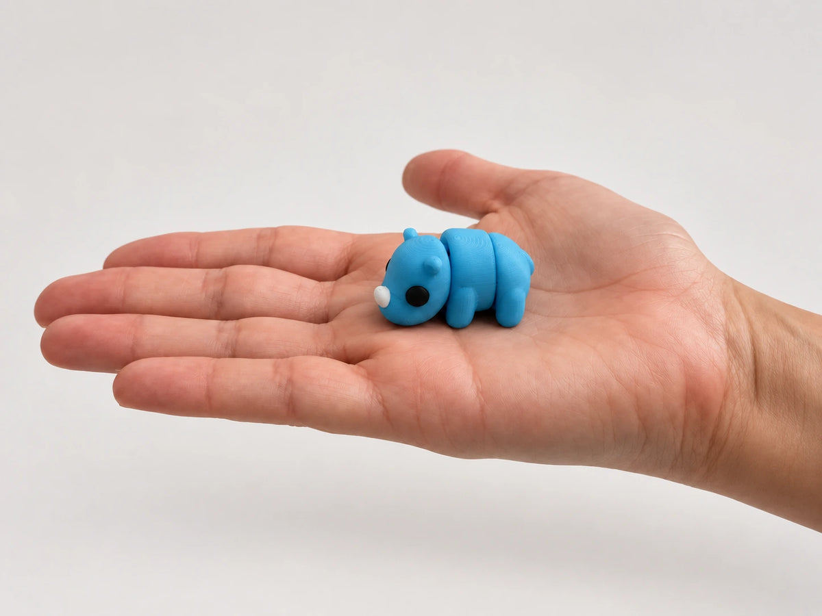 Riley (Rhino) articulated fidget resting in an open hand.