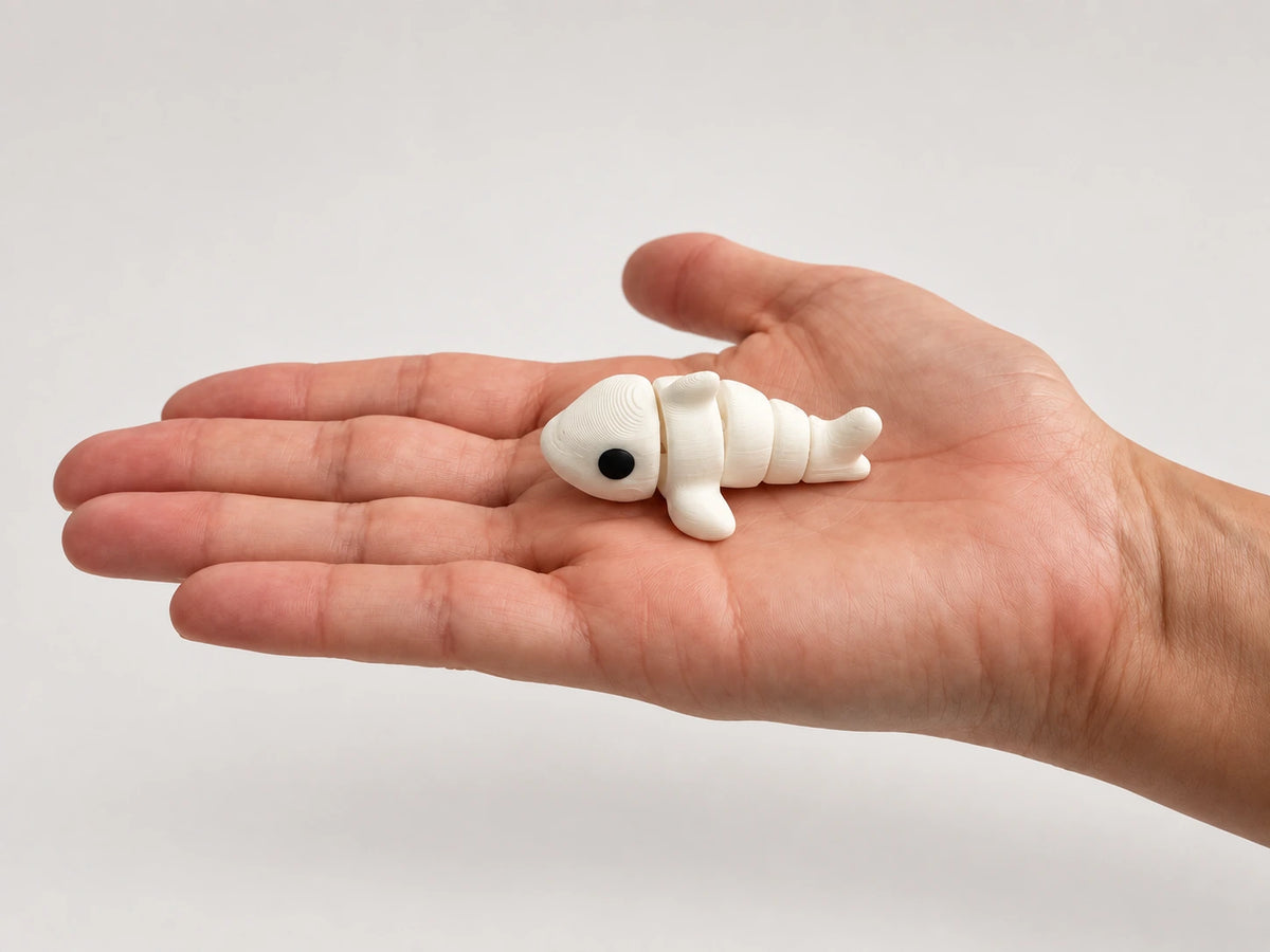 Sally (Shark) articulated fidget resting in an open hand.