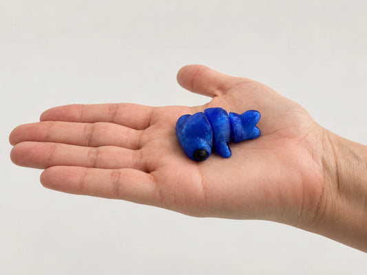 Seal Fidget articulated fidget resting in an open hand.