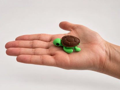 Squirt (Turtle) articulated fidget resting in an open hand.